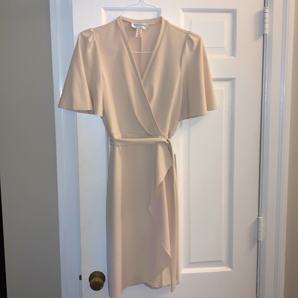 Nice crème dress. Faux wrap. Hits right above knee.
